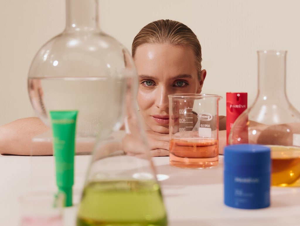 Woman with Parëva products and lab glassware